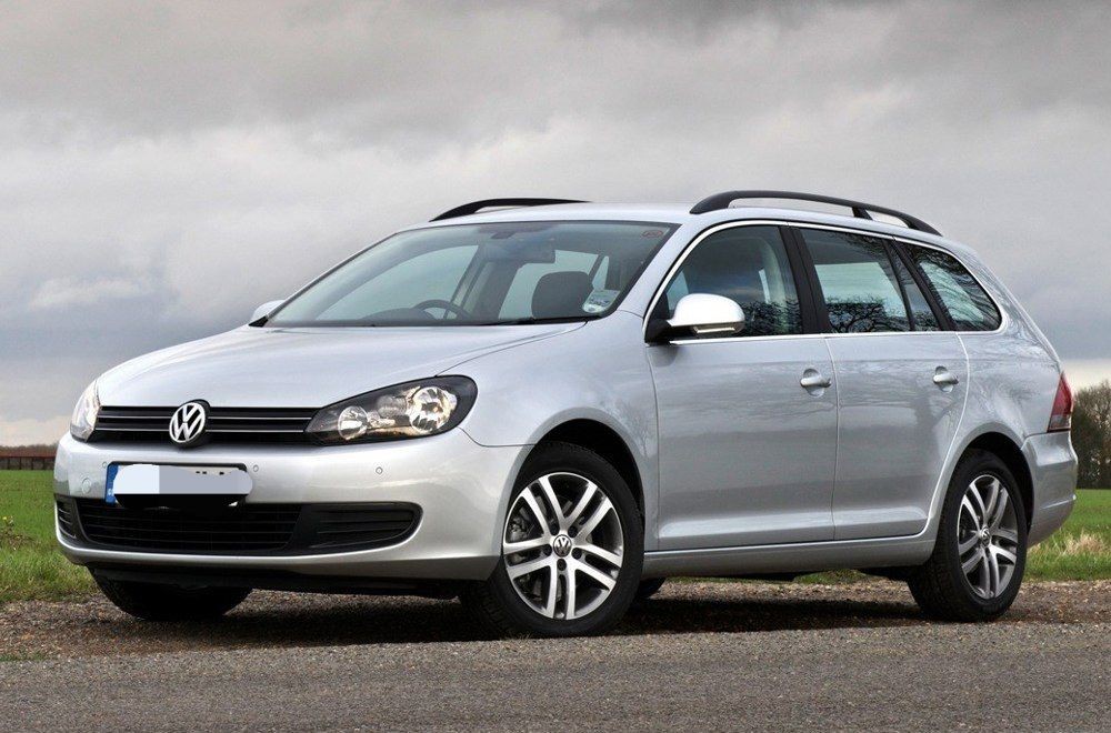 Silver Volkswagen station wagon parked outdoors with cloudy sky in the background.
